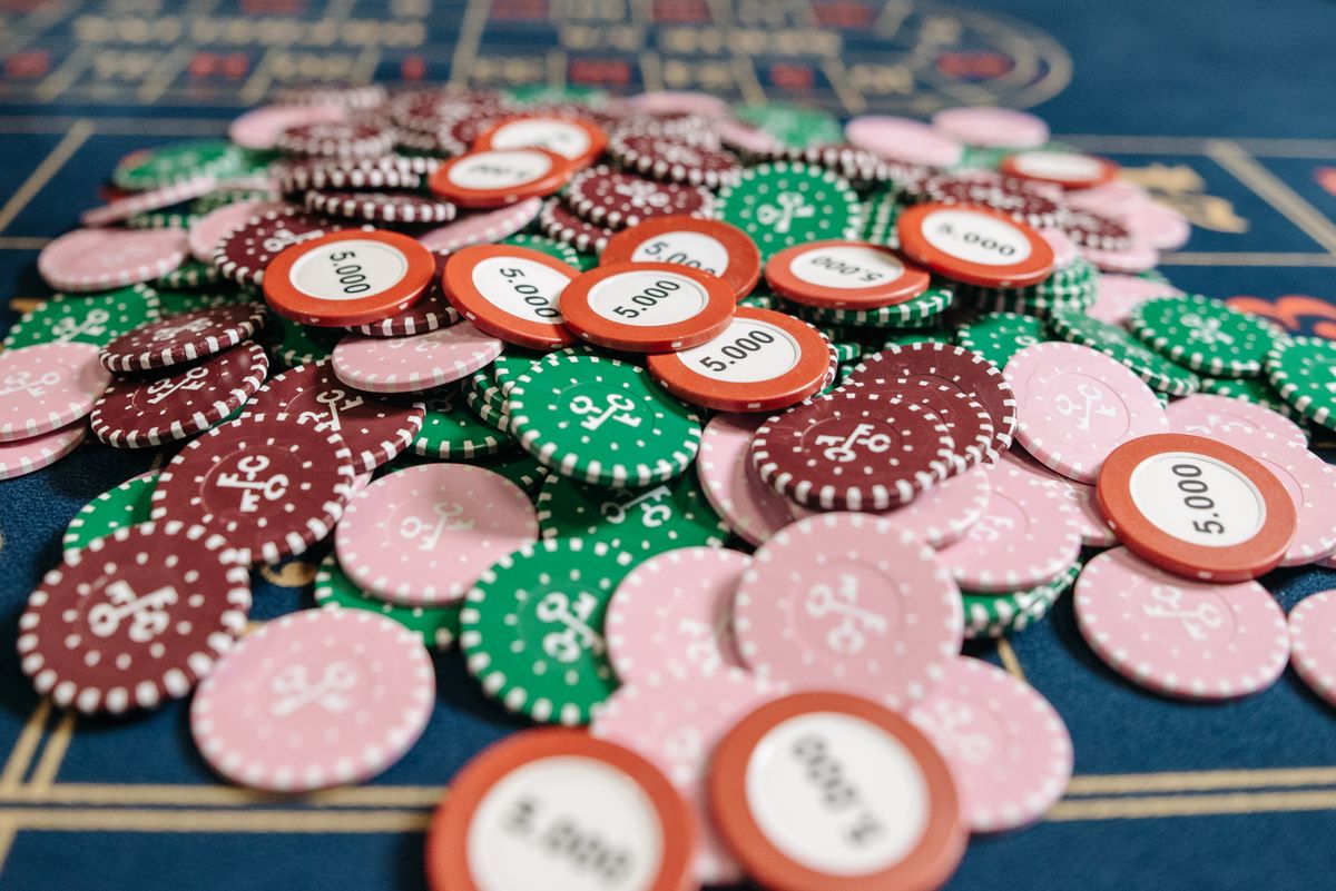 Hands placing bets on a roulette table